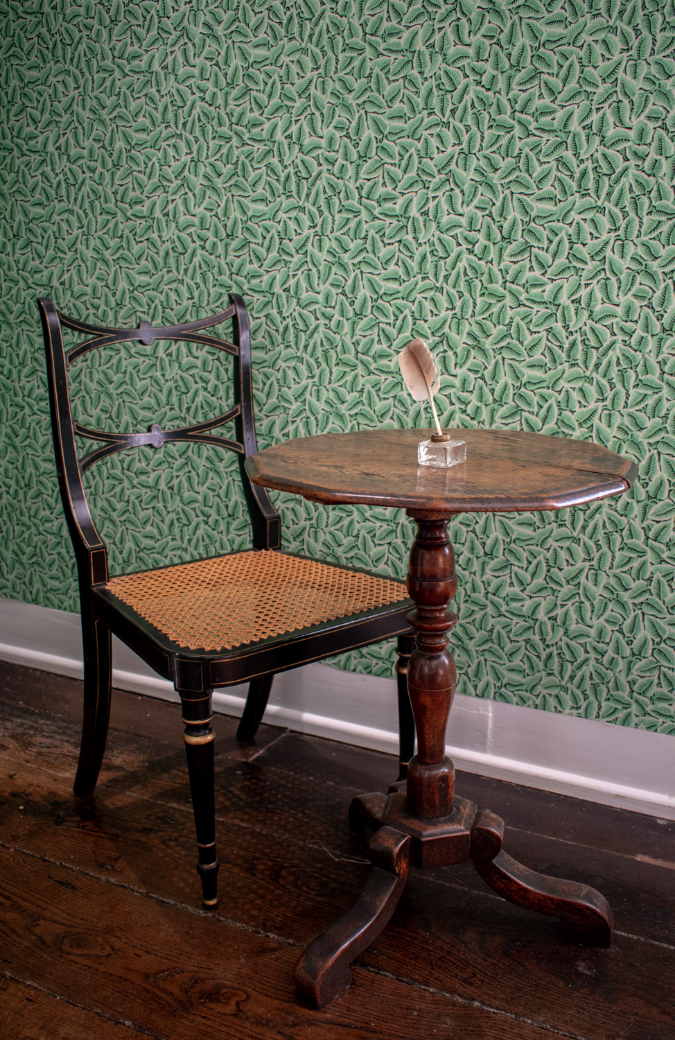 Jane Austen's writing table set against the Chawton Leaf wallpaper in the Dining Parlour