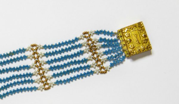 Close up of Jane Austen's blue bead bracelet