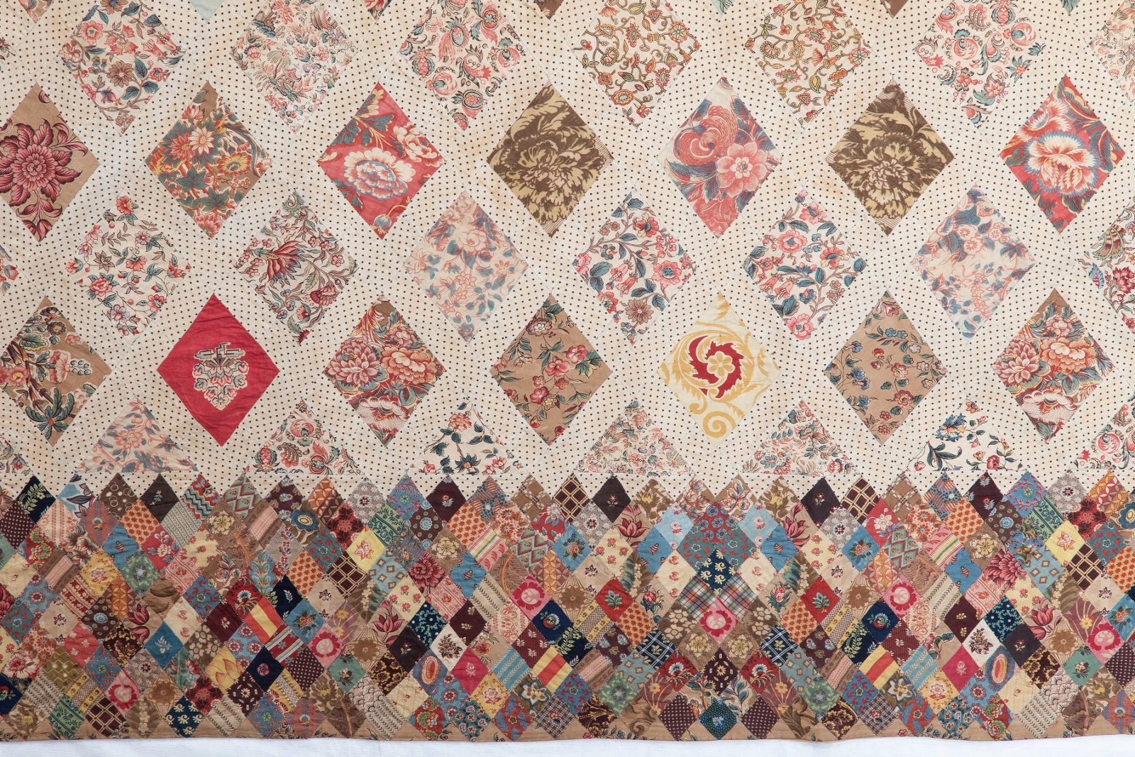 Close up of the Austen family patchwork coverlet, showing border made of small diamonds