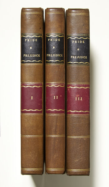 First edition of Pride and Prejudice, a three volume set bound in brown leather with black and maroon bands