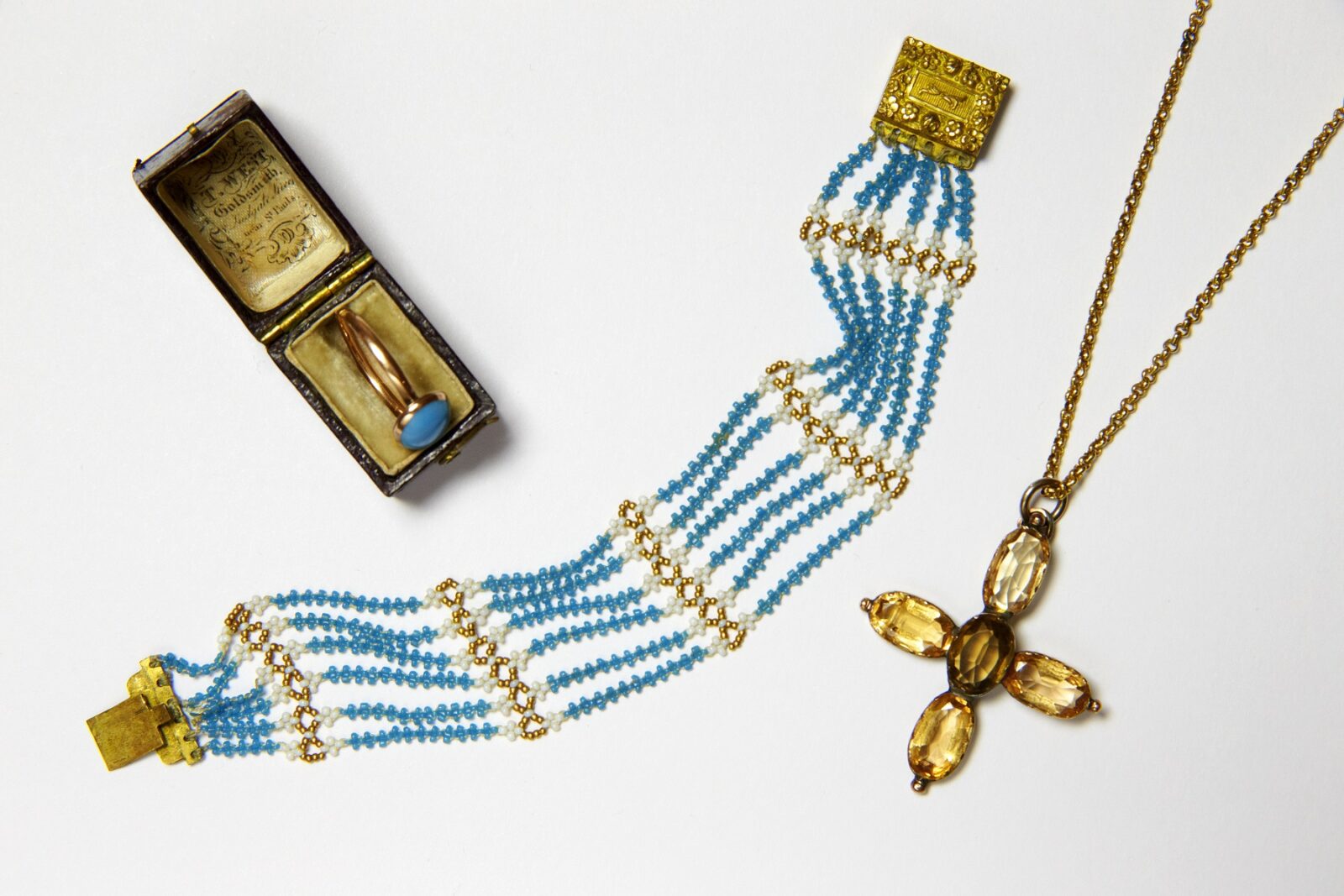 Jane Austen's ring, turquoise bead bracelet and topaz cross on a gold chain, from the collection at Jane Austen's House