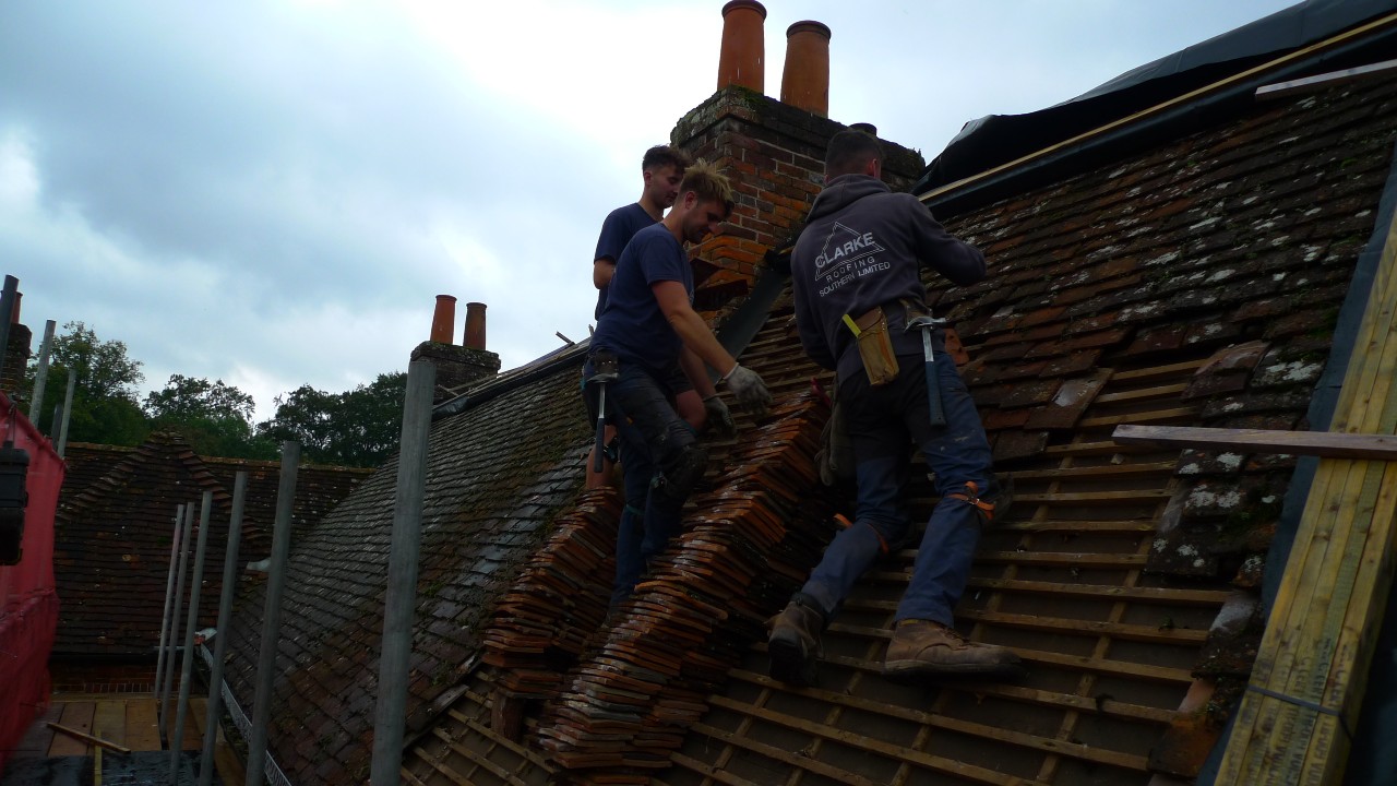 Roofers replacing old tiles on the roof of Jane Austen's House, October 2021.
