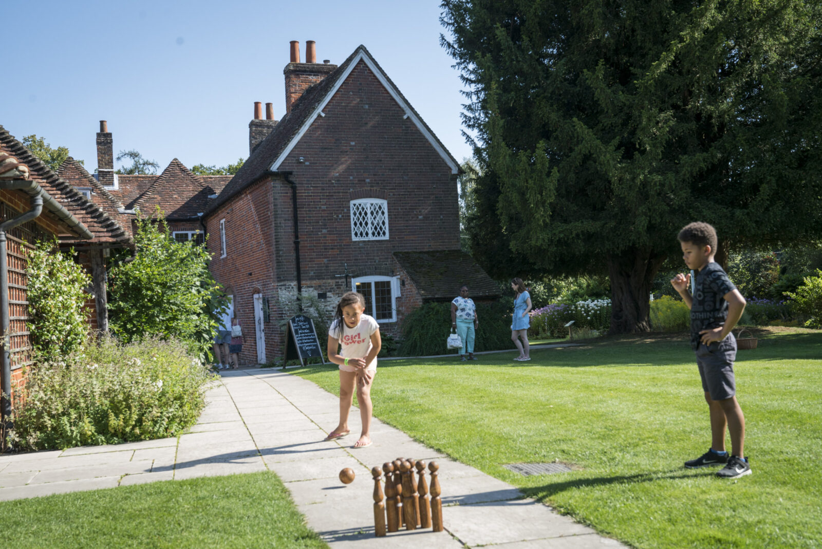 Children play skittles in the garden at Jane Austen's House
