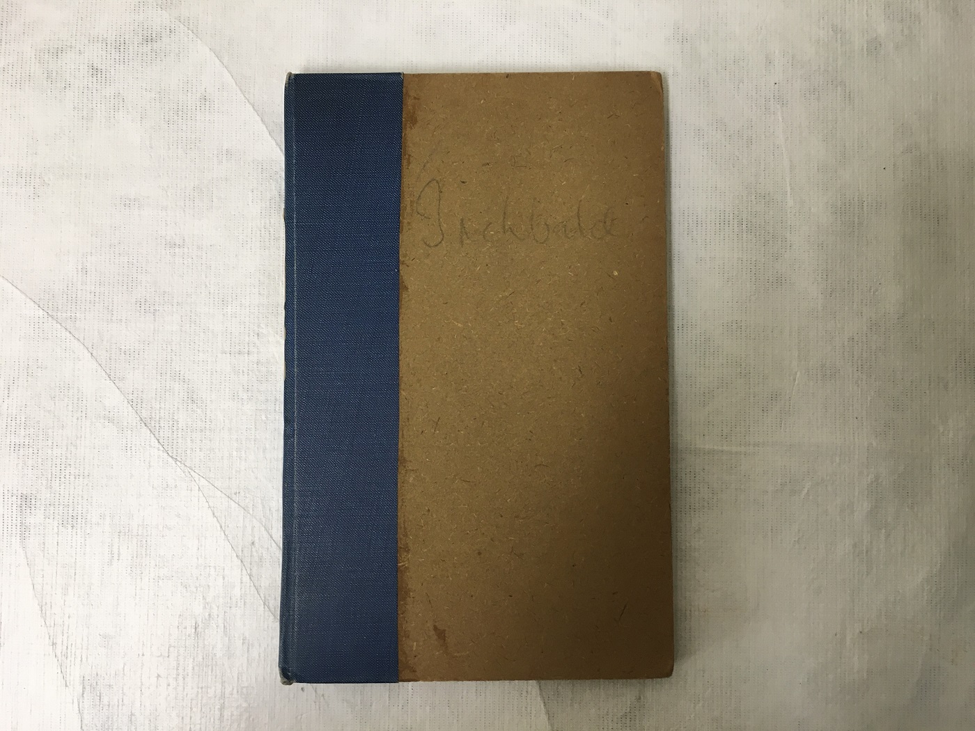 Lovers Vows, first edition. Front cover: brown board with blue tape binding.