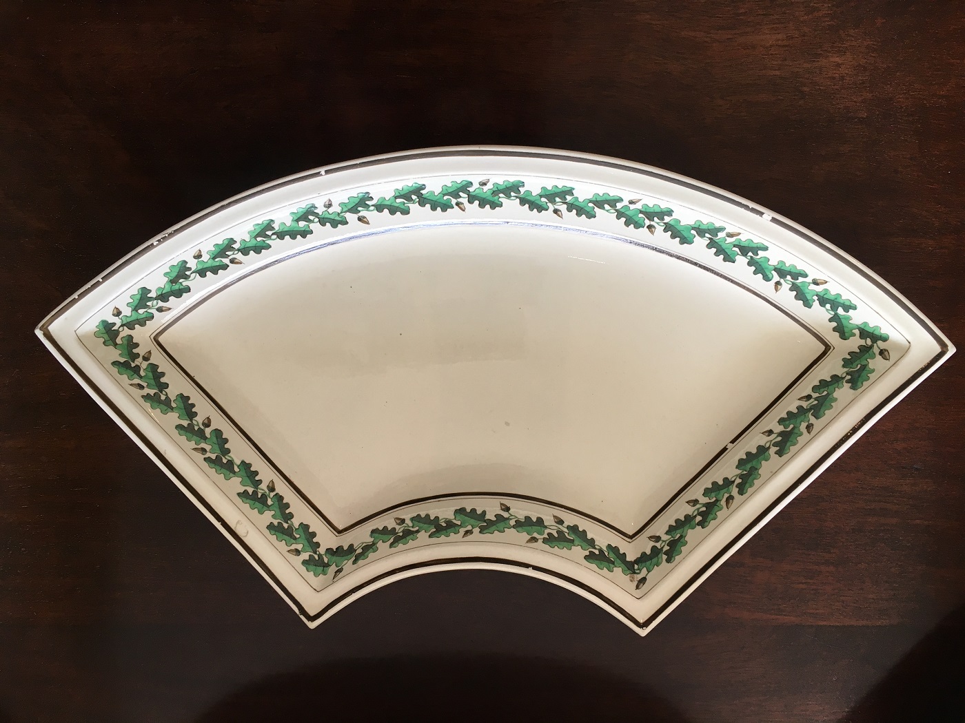 A quarter circle shaped Wedgwood serving dish with an oak leaf patterned border