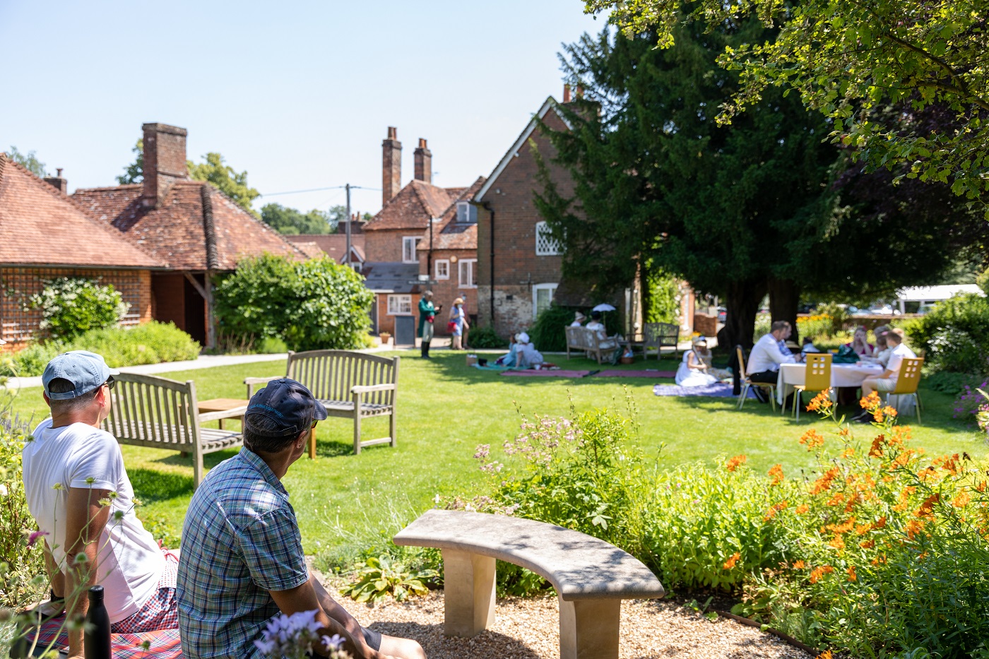 People relax in the garden at Jane Austen's House. Photo by Luke Shears