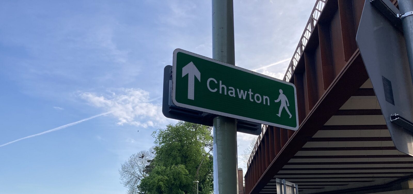 Green street sign pointing the way to walk to Chawton